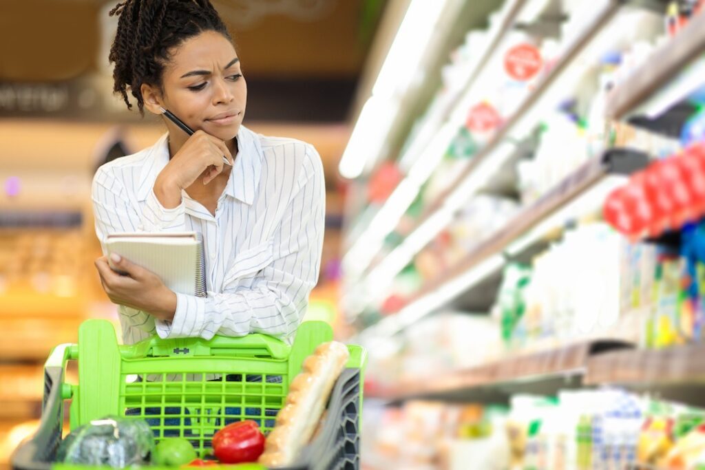 concerned lady buying food calculating food