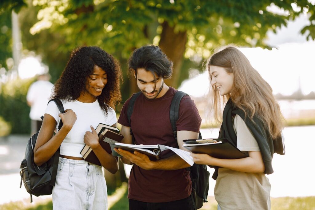 three international students standing in a park an 2022 06 09 15 30 41 utc (1)