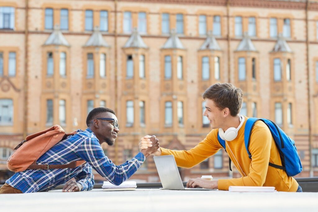 international students shaking hands